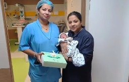 NICU nurse feeding baby