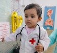 Baby dressed as a doctor at the child vaccination centre in Jangpura